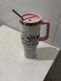 Colorful tumbler with cartoon characters on a white surface
